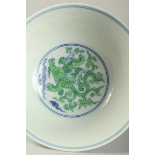 1188 - A CHINESE FAMILLE VERTE PORCELAIN STEM CUP with kui dragons. 15.5cm diameter.