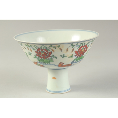 1189 - A CHINESE DONCAI PORCELAIN STEM CUP with flowers and duck.  15.5cm diameter.