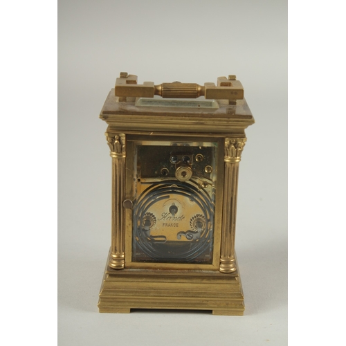 1204 - A SMALL 19TH CENTURY FRENCH BRASS REPEATER  CARRIAGE CLOCK with cream dial, Roman numerals and colum... 