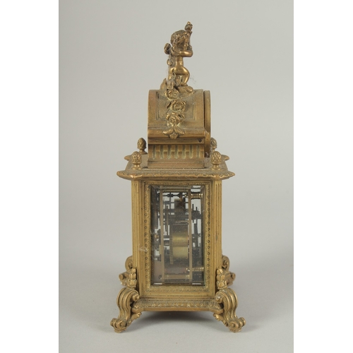 1205 - A 19TH CENTURY FRENCH BRASS CLOCK surrounded by a barometer 8ins high.