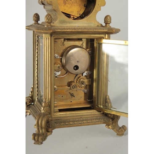 1205 - A 19TH CENTURY FRENCH BRASS CLOCK surrounded by a barometer 8ins high.