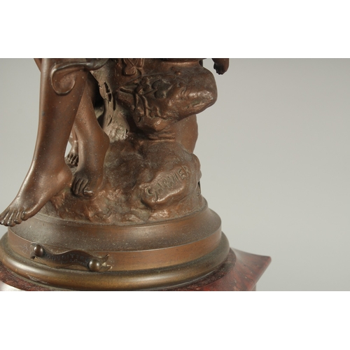 1209 - A 19TH CENTURY RED MARBLE AND SPELTER GROUP MANTLE CLOCK with key and pendulum. 22ins high.