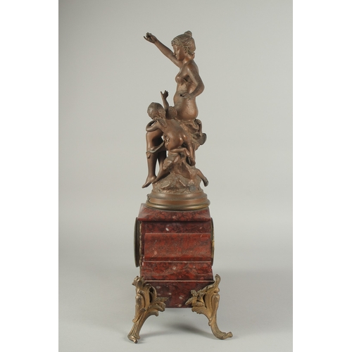 1209 - A 19TH CENTURY RED MARBLE AND SPELTER GROUP MANTLE CLOCK with key and pendulum. 22ins high.