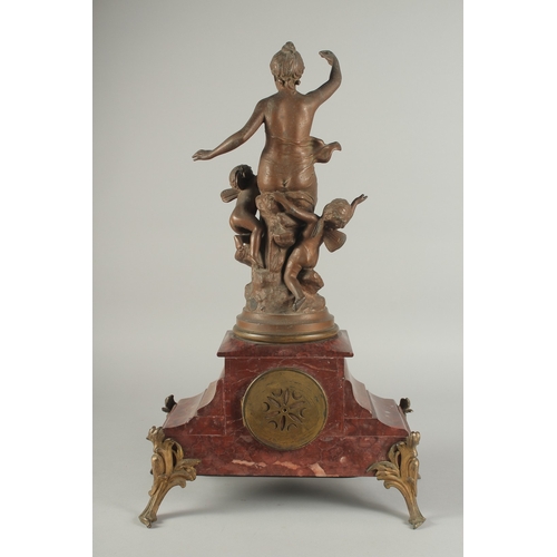 1209 - A 19TH CENTURY RED MARBLE AND SPELTER GROUP MANTLE CLOCK with key and pendulum. 22ins high.