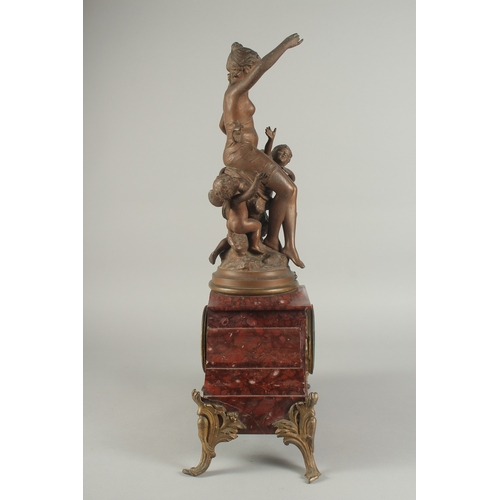 1209 - A 19TH CENTURY RED MARBLE AND SPELTER GROUP MANTLE CLOCK with key and pendulum. 22ins high.