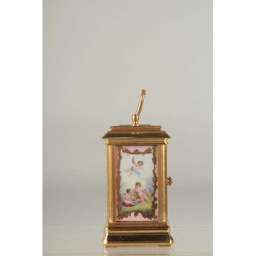 1216 - A GOOD MINIATURE PINK PORCLELAIN MULTI DIAL CARRIAGE CLOCK. 3ins high.