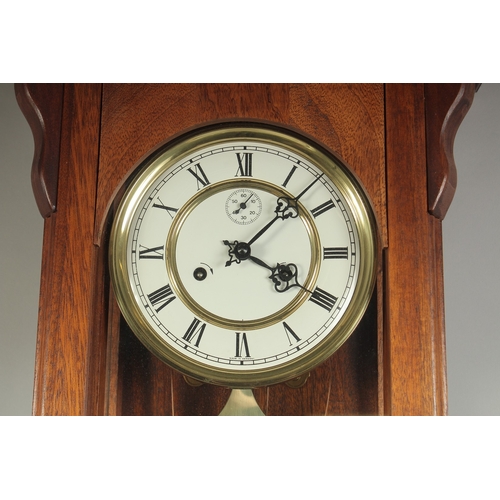 1224 - A VICTORIAN MAHOGANY HANGING WALL CLOCK with white dial, Roman numerals and brass pendulum with two ... 