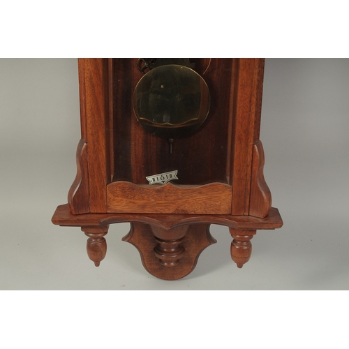 1224 - A VICTORIAN MAHOGANY HANGING WALL CLOCK with white dial, Roman numerals and brass pendulum with two ... 