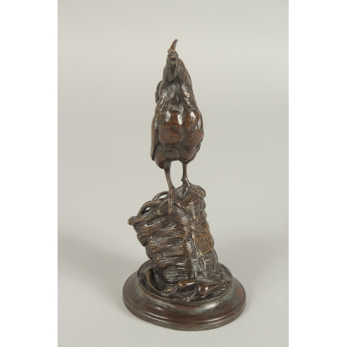 1242 - AUGUSTE NICHOLAS CAIN (1822 - 1994) FRENCH. A BRONZE COCKERAL STANDING IN A FARMYARD BASKET with a c... 