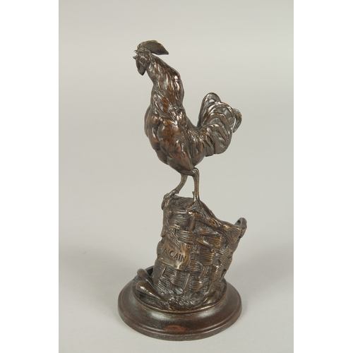 1242 - AUGUSTE NICHOLAS CAIN (1822 - 1994) FRENCH. A BRONZE COCKERAL STANDING IN A FARMYARD BASKET with a c... 