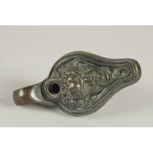 1247 - A ROMAN BRONZE OIL LAMP, the head of Bacchus. 13ins long.