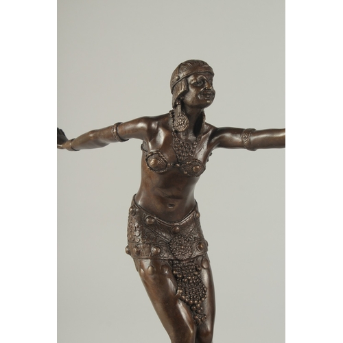 1254 - AFTER D. H. CHIPPARUS. A BRONZE DANCING GIRL. Signed, on a marble base.  19ins high.