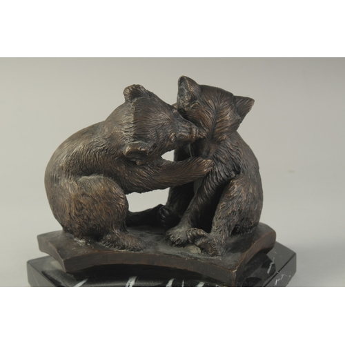 1272 - A CAST BRONZE GROUP OF TWO PLAYFUL BEARS on a  marble base. 7ins high.