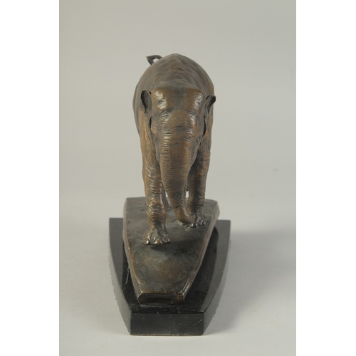 1273 - A BRONZE ELEPHANT on a marble base. 8ins high.