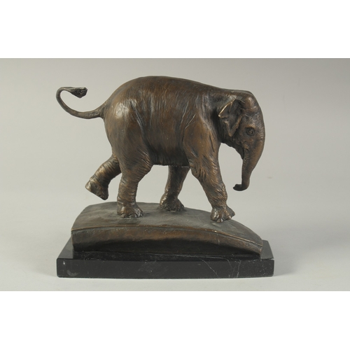 1273 - A BRONZE ELEPHANT on a marble base. 8ins high.