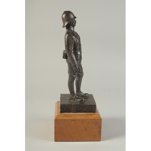 1274 - A SPELTER FIGURE OF A SOLDIER on a wooden base. 9ins high.