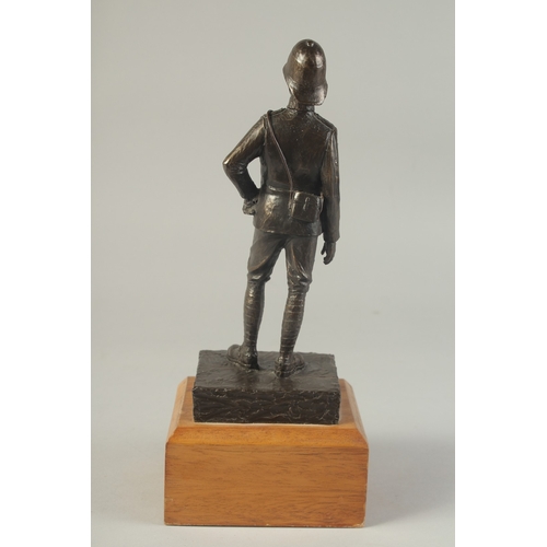 1274 - A SPELTER FIGURE OF A SOLDIER on a wooden base. 9ins high.