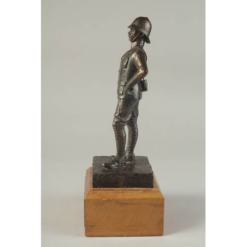 1274 - A SPELTER FIGURE OF A SOLDIER on a wooden base. 9ins high.