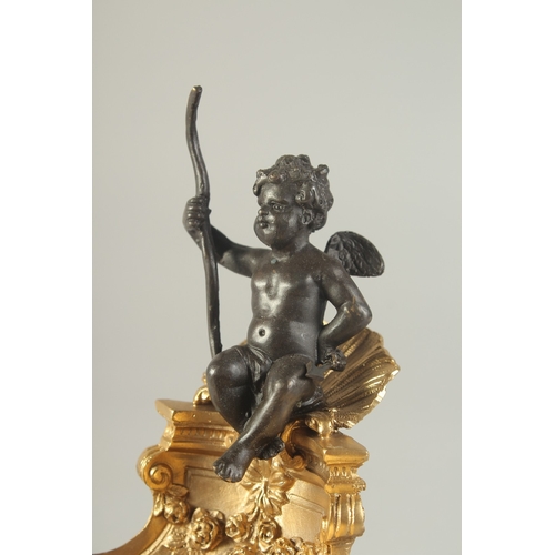 1279 - A BRONZE AND GILT BRONZE TABLE SALT modelled as a cherub, seated on a shell shaped dish. 7ins high.... 