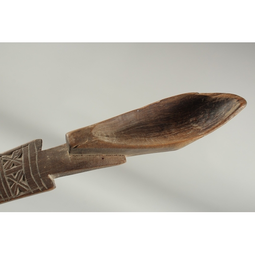 1283 - A CARVED WOOD LONG  SPOON. 15ins long.