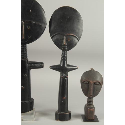 1285 - A FAMILY OF FOUR CARVED WOOD AFRICAN FIGURES. 15ins, 13ins, 11ins & 6ins.