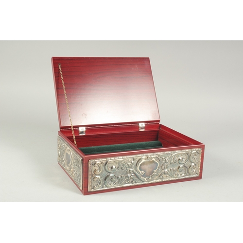 1297 - A GOOD REPOUSSE SILVER CASKET, silver top and sides with velvet interior. 9.5ins long, 6.5ins wide, ... 