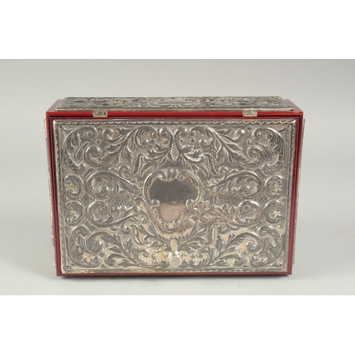 1297 - A GOOD REPOUSSE SILVER CASKET, silver top and sides with velvet interior. 9.5ins long, 6.5ins wide, ... 