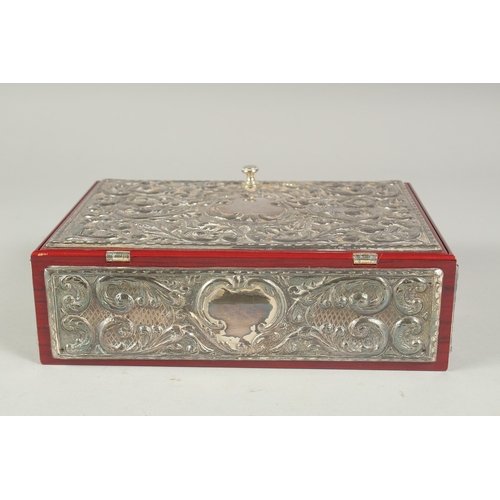 1297 - A GOOD REPOUSSE SILVER CASKET, silver top and sides with velvet interior. 9.5ins long, 6.5ins wide, ... 