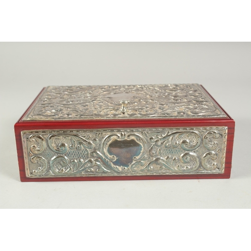 1297 - A GOOD REPOUSSE SILVER CASKET, silver top and sides with velvet interior. 9.5ins long, 6.5ins wide, ... 