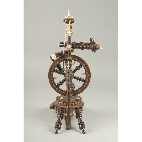 1305 - A GOOD WOODEN AND BONE INLAID MINIATURE SPINNING WHEEL. 14ins high.