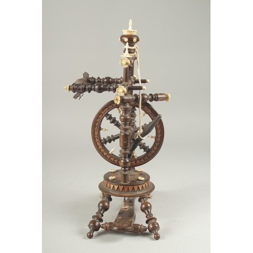 1305 - A GOOD WOODEN AND BONE INLAID MINIATURE SPINNING WHEEL. 14ins high.