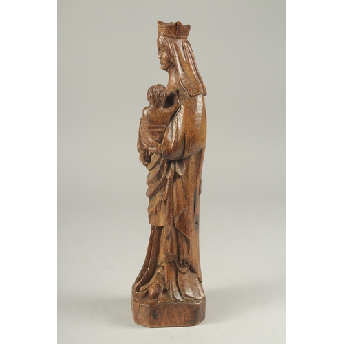 1306 - AN 18TH CENTURY CARVED WOOD MADONNA AND CHILD. 12ins high.