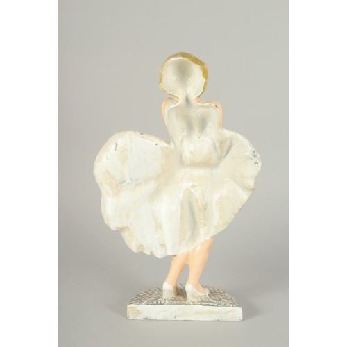 1310 - A PAINTED CAST IRON FIGURE OF MARILYN MUNROE. 12ins high.