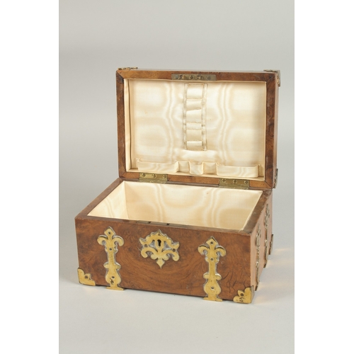 1328 - A GOOD 19TH CENTURY FIGURED WALNUT BRASS BOUND CASKET with velvet interior. 8ins long.