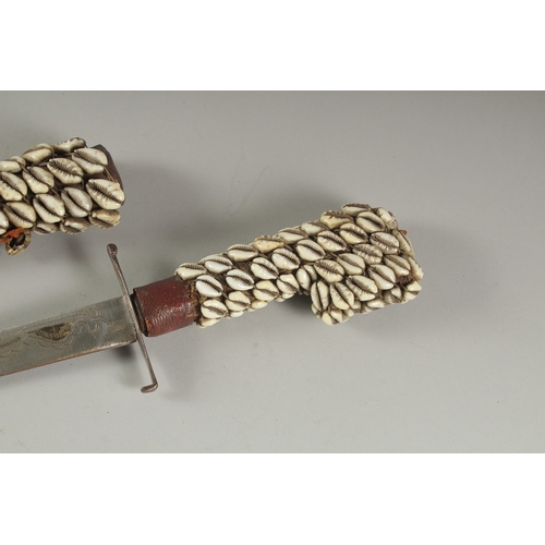 A COWIE SHELL COVERED DAGGER AND SHEATH. 19ins long.