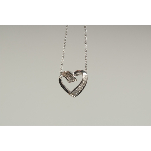 1580 - A 14CT WHITE GOLD AND DIAMOND HEART SHAPED PENDANT on a chain.