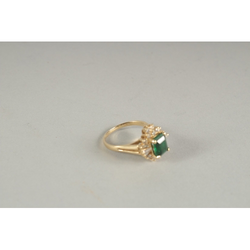 1594 - A GOOD YELLOW GOLD EMERALD AND DIAMOND RING.