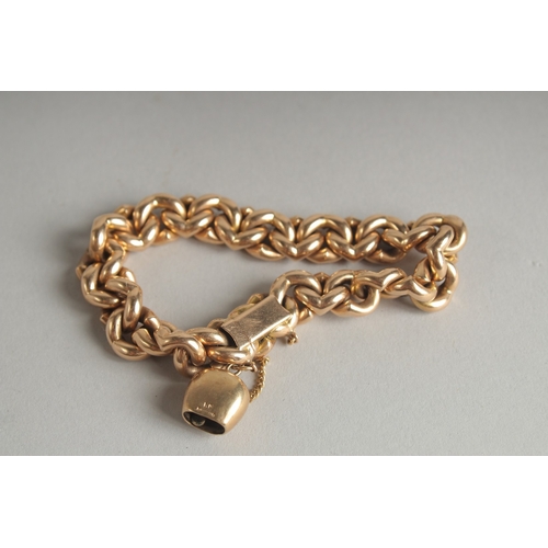 1595 - A 15CT GOLD CHAIN LINK BRACELET and a charm. Weight: 28.9gms.