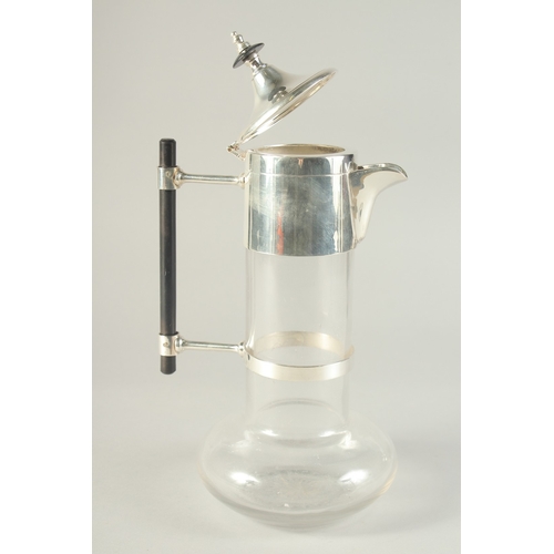 1689 - A CHRISTOPHER DRESSER STYLE CLARET JUG with plated mounts.11ins high.