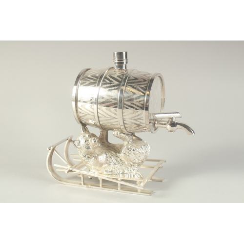 1690 - A NOVELTY SILVER PLATED LIQUEUR DISPENSER modelled as a barrel being held aloft by a bear lying on a... 