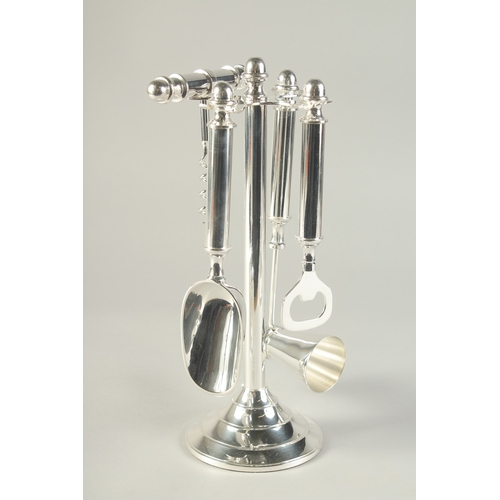 1693 - A SILVER PLATED STAND MOUNTED WITH BAR ACCESSORIES.  10.5ins high.