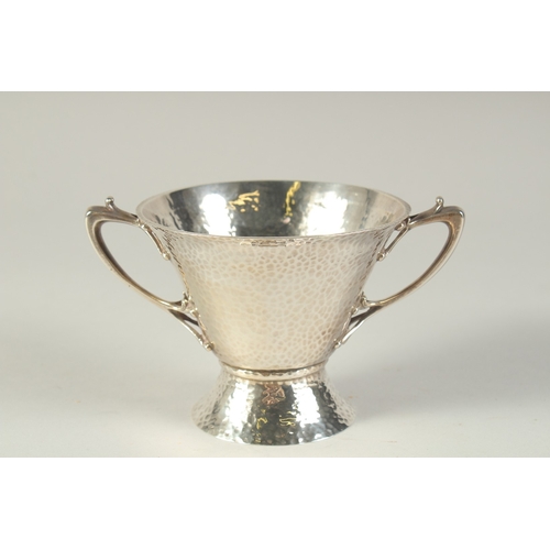 1701 - AN ART DECO HAMMERED TWO HANDLED SILVER BOWL. 4.5ins diameter, London 1904, maker: W.K.S. Weight: 8o... 