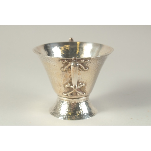 1701 - AN ART DECO HAMMERED TWO HANDLED SILVER BOWL. 4.5ins diameter, London 1904, maker: W.K.S. Weight: 8o... 