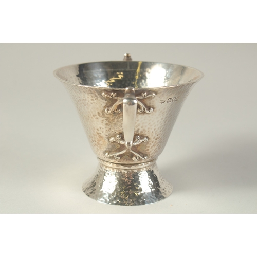 1701 - AN ART DECO HAMMERED TWO HANDLED SILVER BOWL. 4.5ins diameter, London 1904, maker: W.K.S. Weight: 8o... 