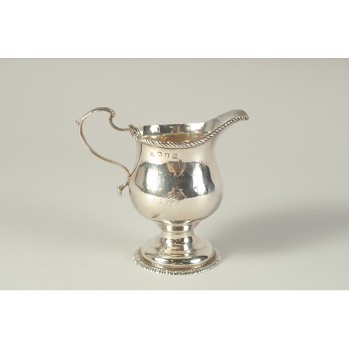 1702 - A GEORGE III CREAM JUG. London 1768.  Maker: S. M.