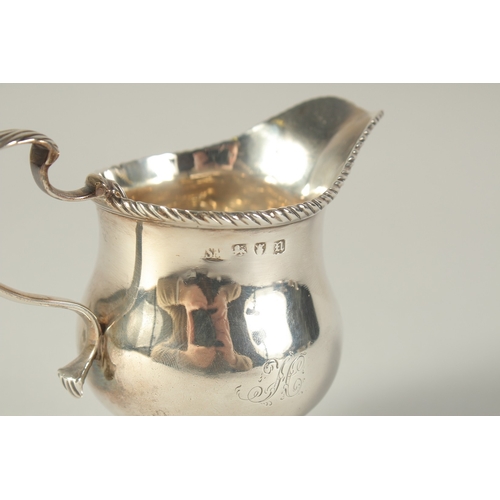 1702 - A GEORGE III CREAM JUG. London 1768.  Maker: S. M.