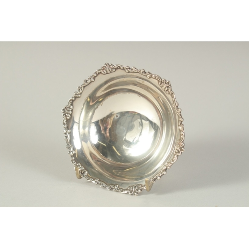 1705 - A CIRCULAR SILVER BOWL with cast rim.  4.75ins diameter. London 1935,  and a small cup. Birmingham 1... 