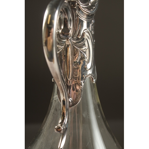 1708 - A PLAIN GLASS CLARET JUG with silver mounts and handle. London 1933.