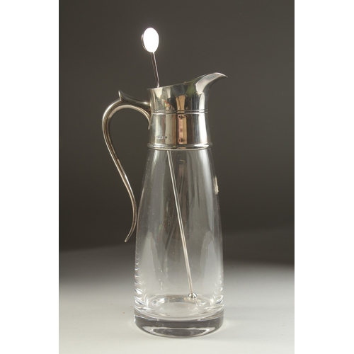 1709 - A PLAIN GLASS LEMONADE JUG with silver mount and handle. London 1979.