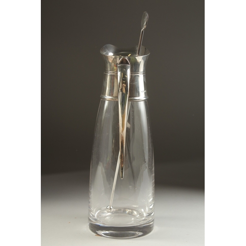 1709 - A PLAIN GLASS LEMONADE JUG with silver mount and handle. London 1979.